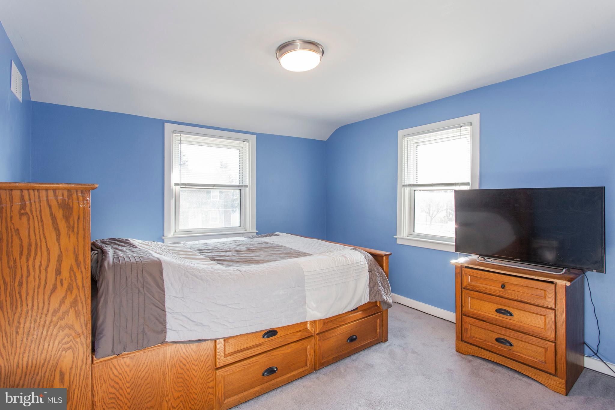 1025 Edgerton Road Secane, PA 19018 - Photo 14 of 21 a bedroom with a bed and flat tv screen on the dresser