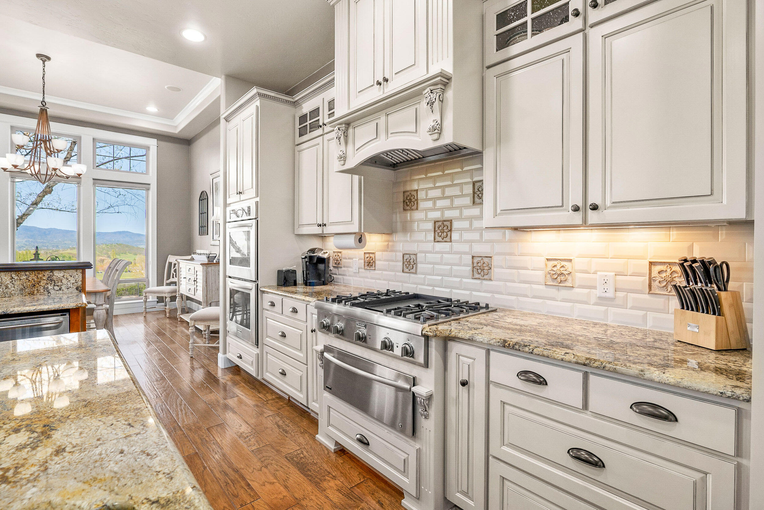 5709 Hughes Road Medford, OR 97504 - Photo 18 of 70 a kitchen with stainless steel appliances granite countertop a stove and a sink