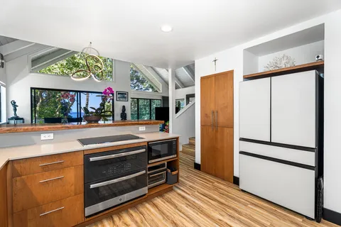 a kitchen with stainless steel appliances granite countertop a refrigerator and a stove