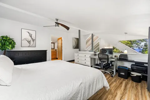 a bedroom with a bed and a flat screen tv