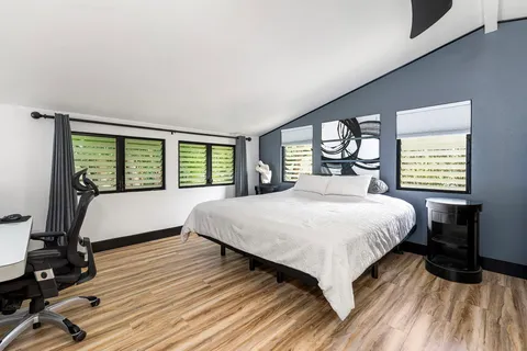 a bedroom with a large bed and a large window