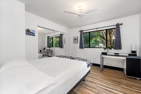 a bedroom with a large bed and a large window