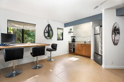 a living room with furniture a rug and a clock