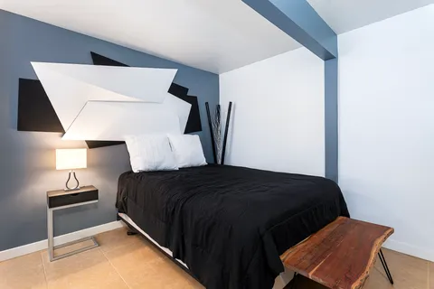 a bedroom with a bed and window