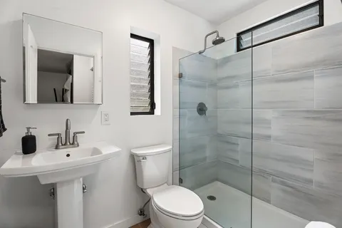 a bathroom with a toilet sink and shower