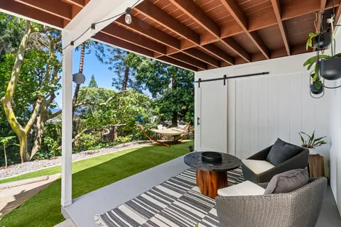 a view of a porch with furniture and yard
