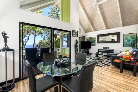 a dining room with furniture a fireplace and wooden floor