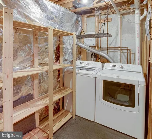 a spacious bathroom with a granite countertop toilet sink and mirror