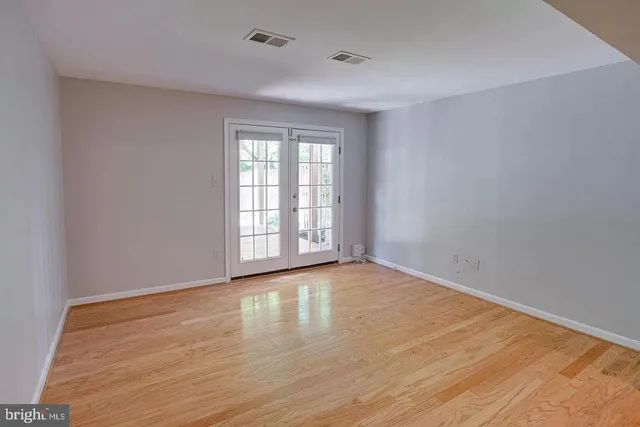 a view of an empty room and wooden floor