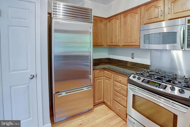 a kitchen with appliances and cabinets