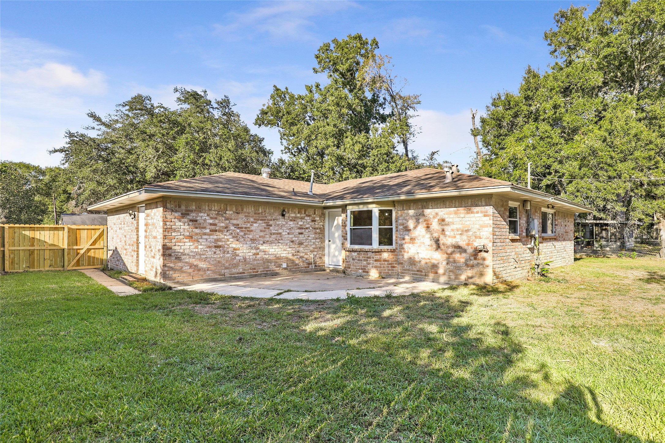 906 Broad Ripple Drive Huffman, TX 77336 - Photo 27 of 30 A nice large backyard with a patio just off the kitchen.
