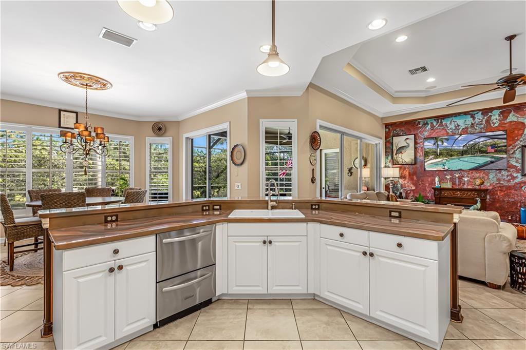 12567 Grandezza Circle Estero, FL 33928 - Photo 13 of 47 a kitchen with white cabinets and sink