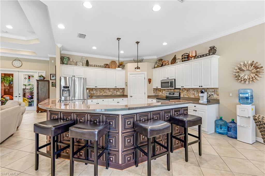 12567 Grandezza Circle Estero, FL 33928 - Photo 15 of 47 a kitchen with a table and chairs in it