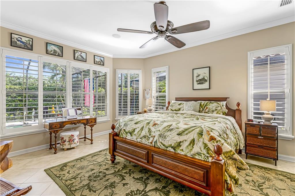 12567 Grandezza Circle Estero, FL 33928 - Photo 16 of 47 a bed sitting in a bedroom next to a window