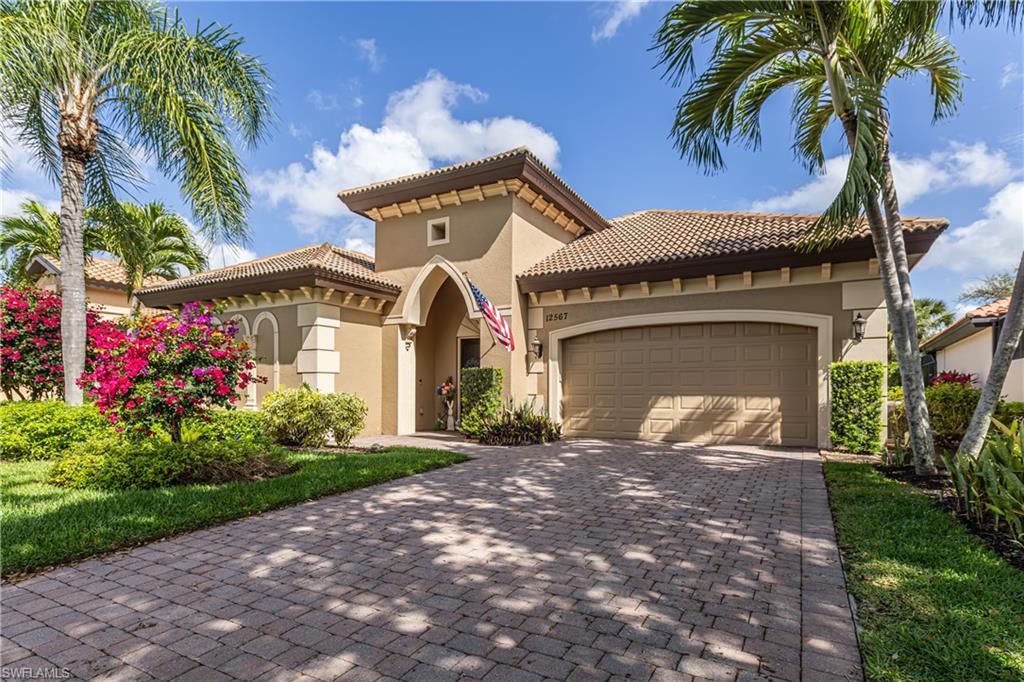 12567 Grandezza Circle Estero, FL 33928 - Photo 2 of 47 a front view of a house with a garden