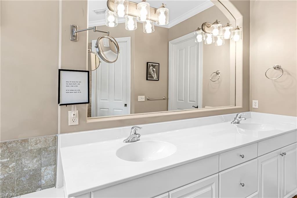 12567 Grandezza Circle Estero, FL 33928 - Photo 21 of 47 a bathroom with a sink and a mirror