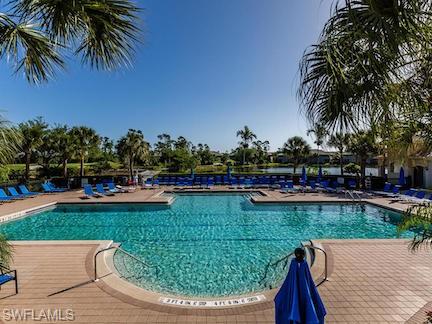 12567 Grandezza Circle Estero, FL 33928 - Photo 30 of 47 a view of a swimming pool with a garden and trees