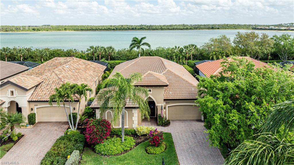 12567 Grandezza Circle Estero, FL 33928 - Photo 3 of 47 a view of a house with a yard and a lake view