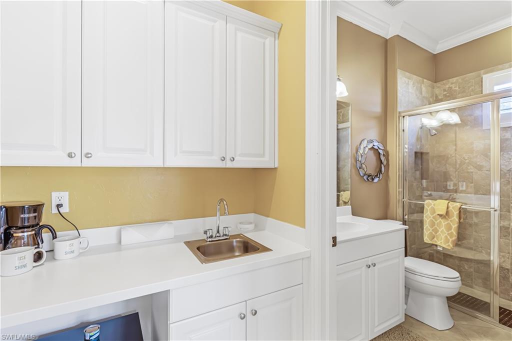 12567 Grandezza Circle Estero, FL 33928 - Photo 8 of 47 a view of bathroom with a sink and a washer dryer
