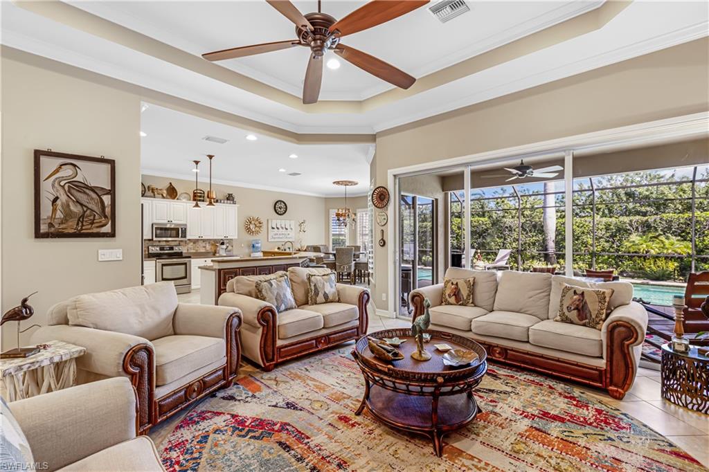 12567 Grandezza Circle Estero, FL 33928 - Photo 9 of 47 a living room with furniture a rug potted plant and a large window