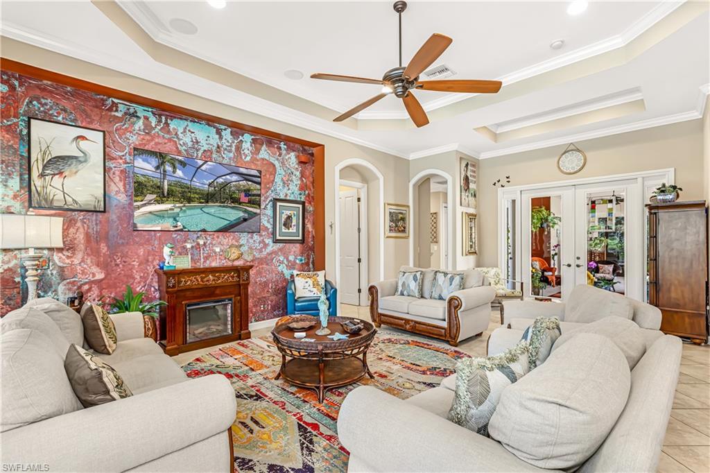 12567 Grandezza Circle Estero, FL 33928 - Photo 10 of 47 a living room with furniture a fireplace and a flat screen tv
