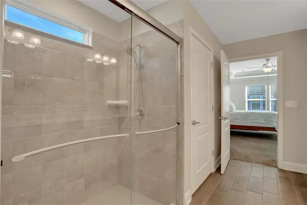a bathroom with a glass door shower