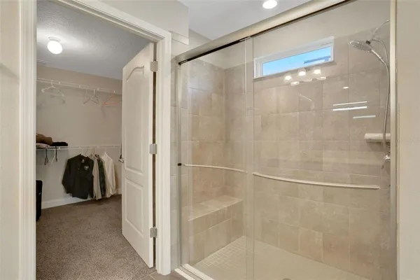 a bathroom with a glass shower door