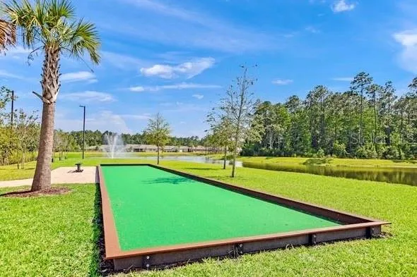 an aerial view of a house with swimming pool and lake view