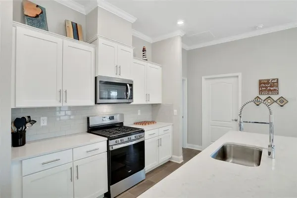 a kitchen with cabinets a sink and a stove
