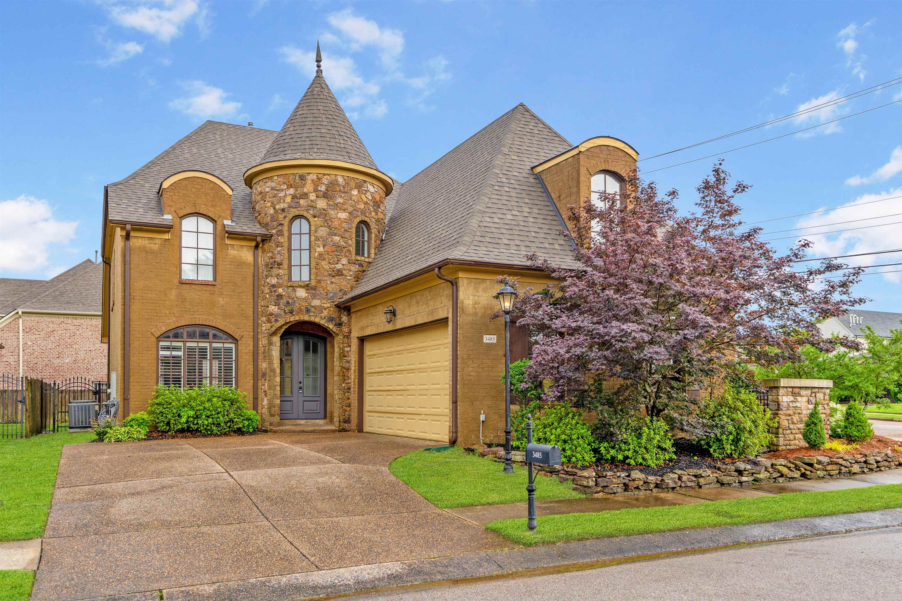 a front view of a house with a garden
