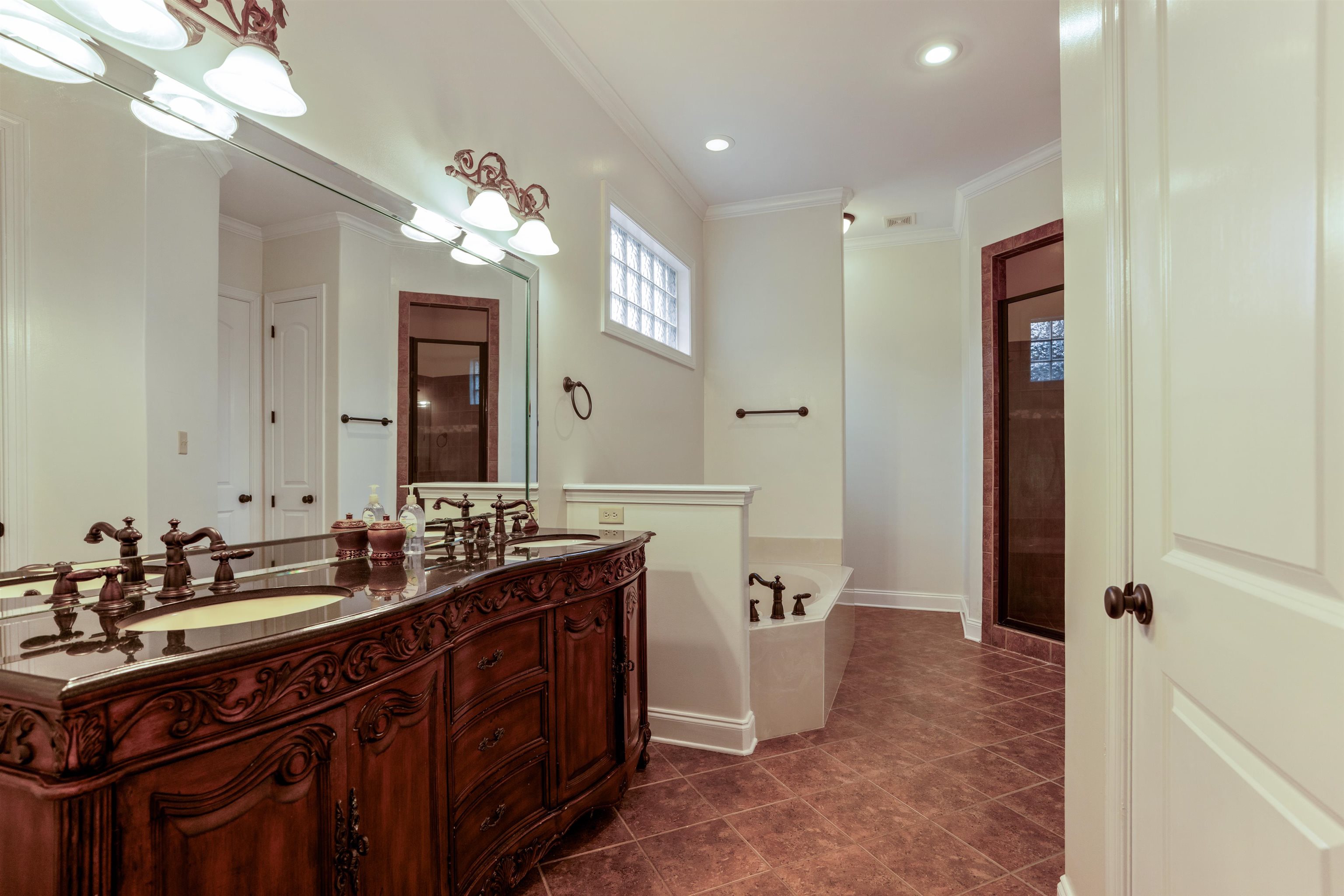 3485 East Taplow Way Collierville, TN 38017 - Photo 10 of 38 a spacious bathroom with a double vanity sink a large mirror and a shower