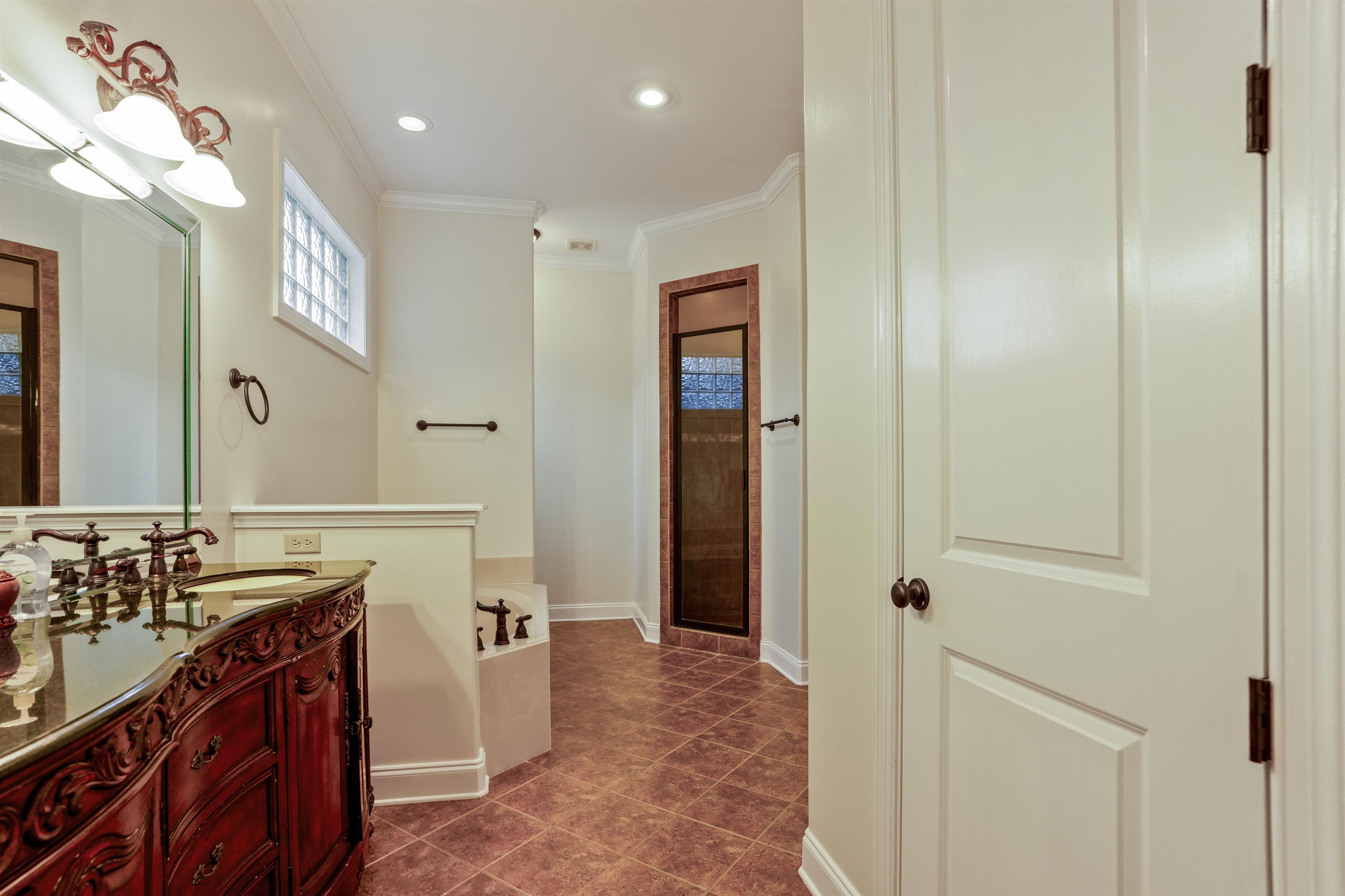 3485 East Taplow Way Collierville, TN 38017 - Photo 11 of 38 a bathroom with a sink and a mirror
