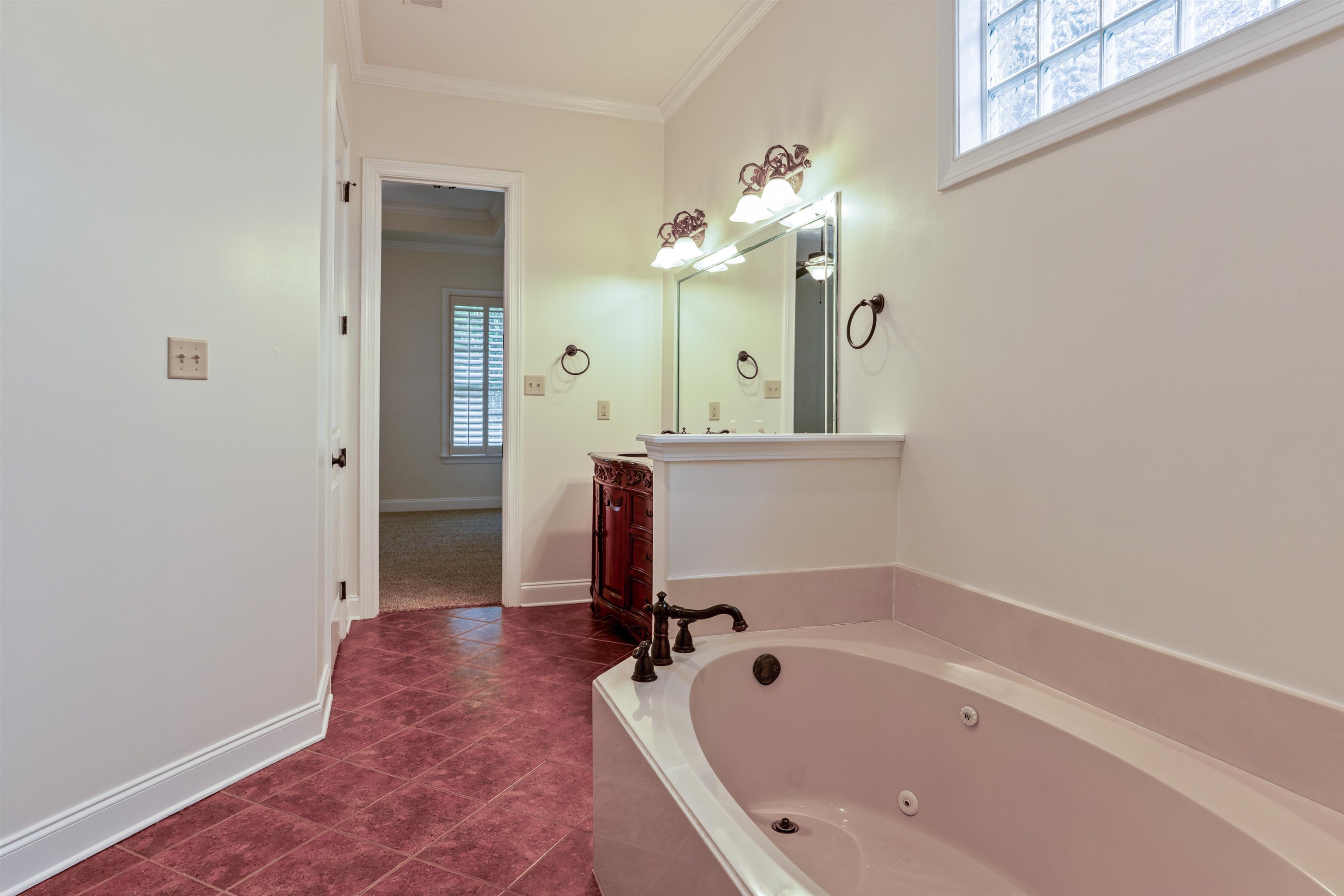 3485 East Taplow Way Collierville, TN 38017 - Photo 12 of 38 a bathroom with a tub sink and mirror