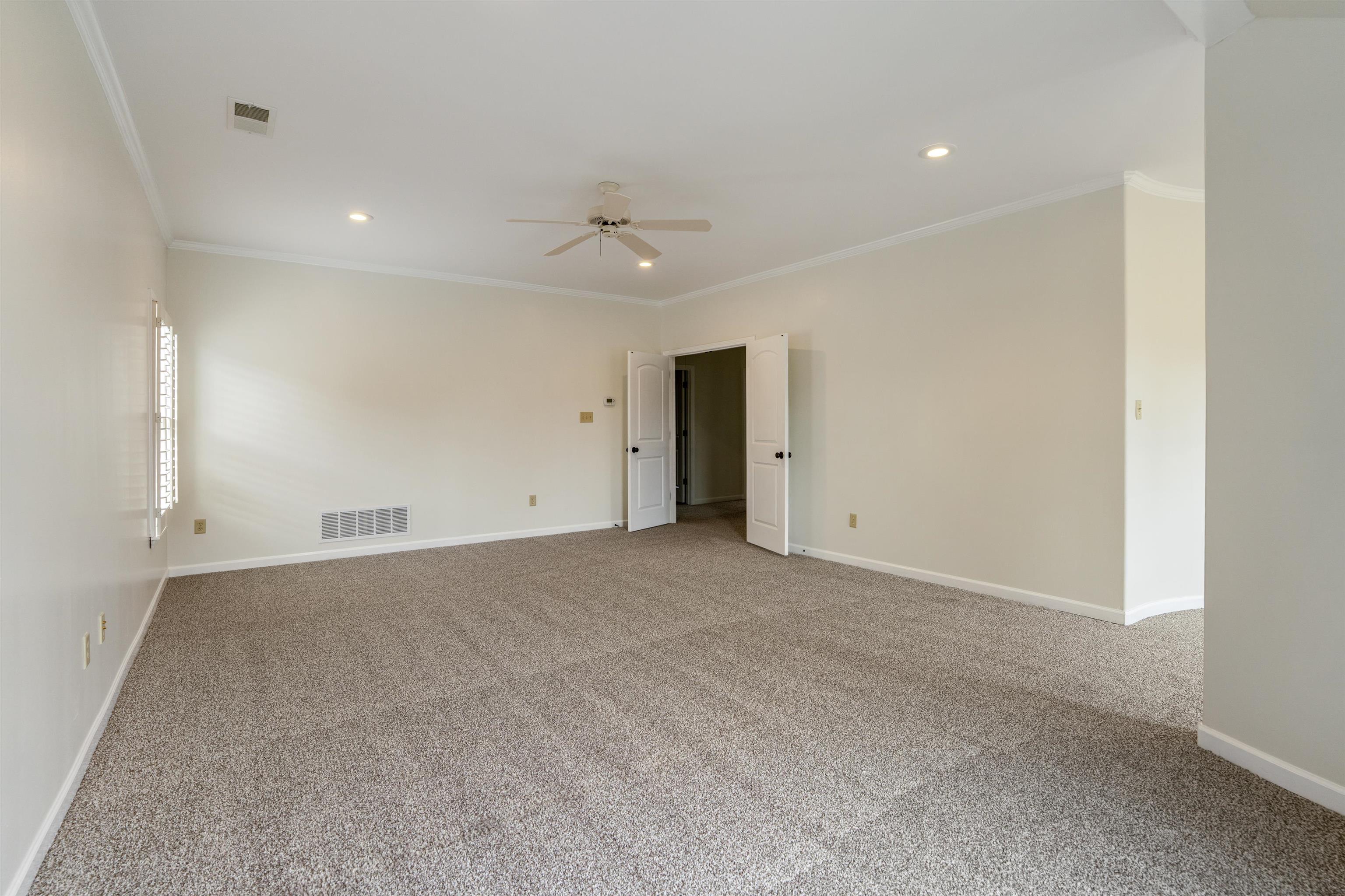 3485 East Taplow Way Collierville, TN 38017 - Photo 17 of 38 an empty room with an entryway and fan