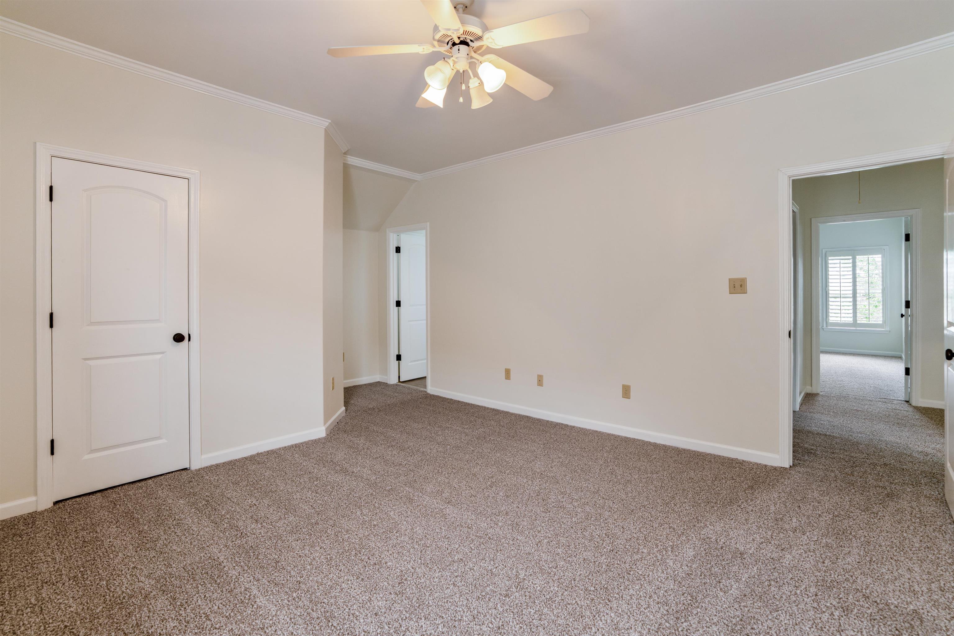 3485 East Taplow Way Collierville, TN 38017 - Photo 23 of 38 Unfurnished bedroom featuring carpet floors, ornamental molding, ceiling fan, and vaulted ceiling