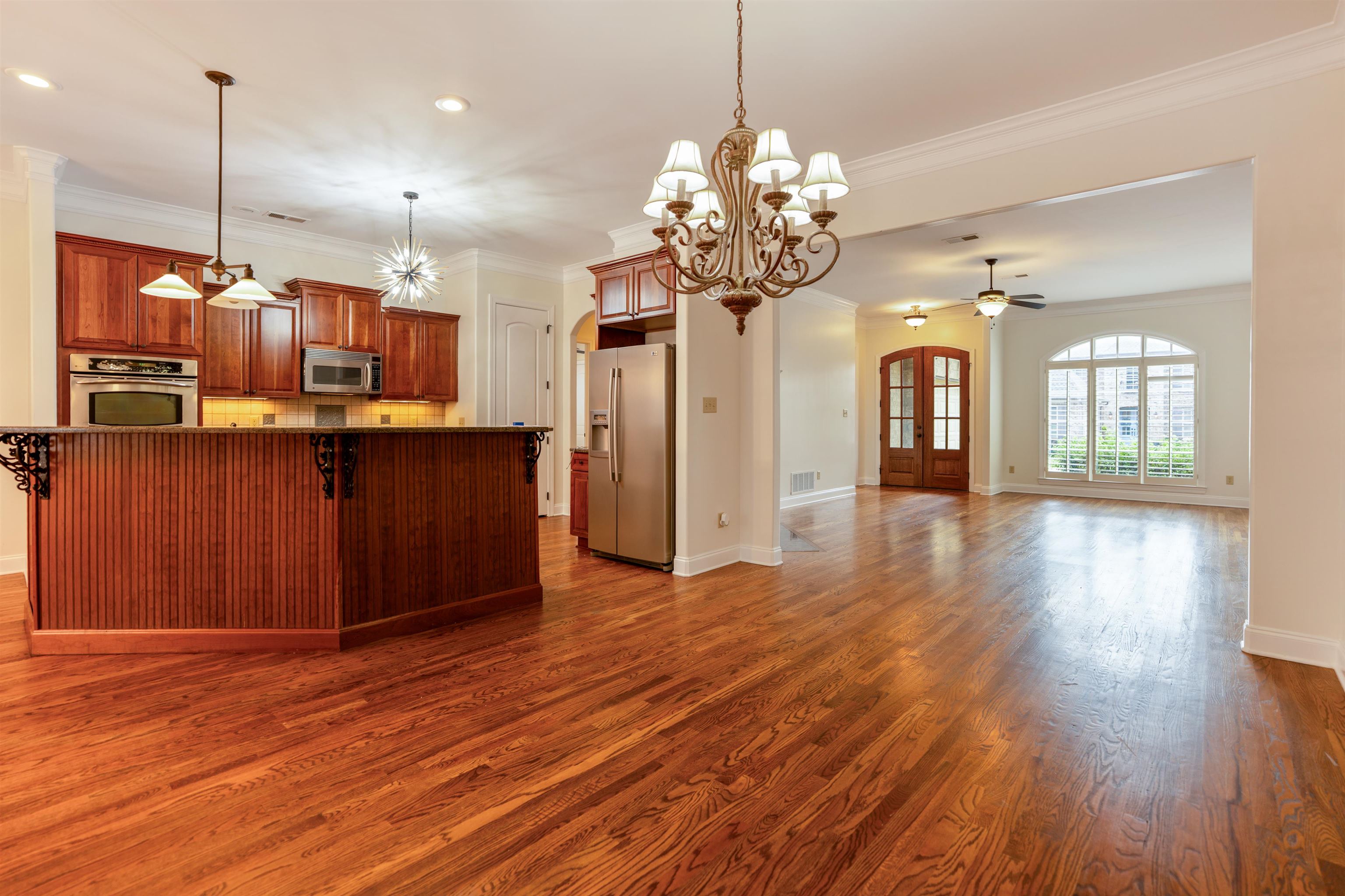 3485 East Taplow Way Collierville, TN 38017 - Photo 38 of 38 a view of a room with wooden floor and chandelier