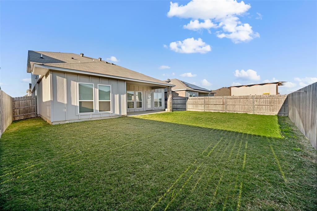 11304 Solar Street Lorena, TX 76655 - Photo 2 of 34 Back of house with a patio area, a fenced backyard, and roof with shingles
