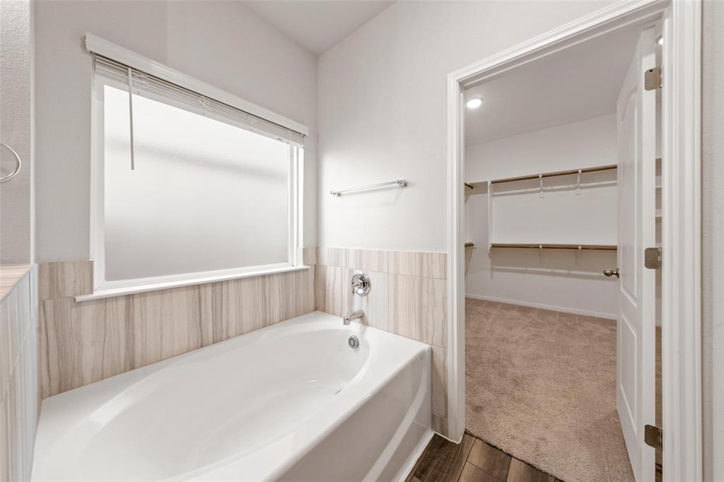 11304 Solar Street Lorena, TX 76655 - Photo 21 of 34 Full bathroom with a spacious closet, a bath, and carpet