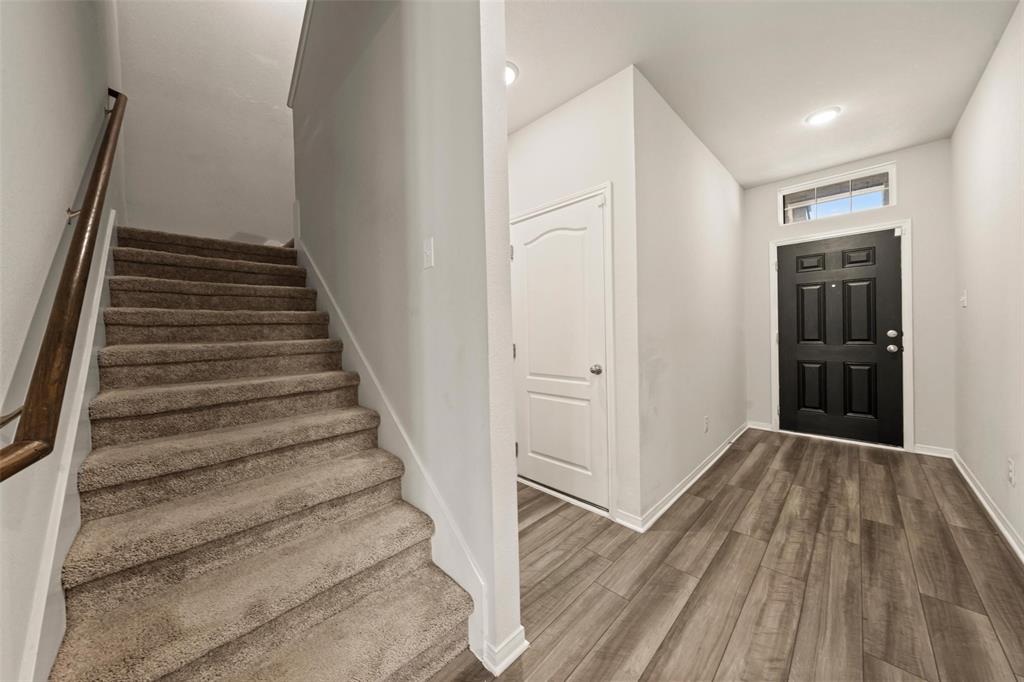 11304 Solar Street Lorena, TX 76655 - Photo 4 of 34 Foyer entrance with stairs and dark wood-type flooring