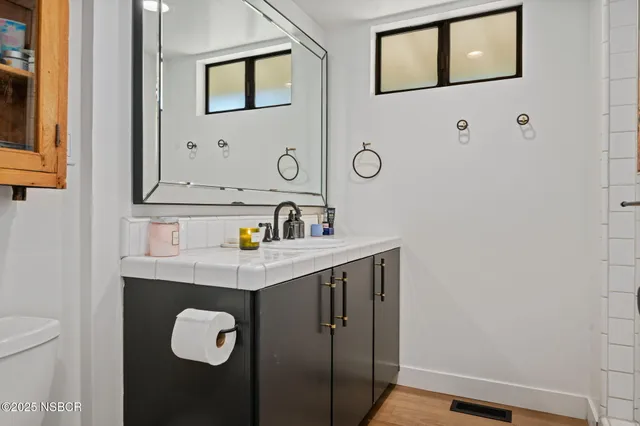 a bathroom with a double vanity sink mirror and shower