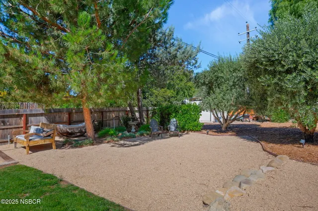 a front view of a house with a garden and yard