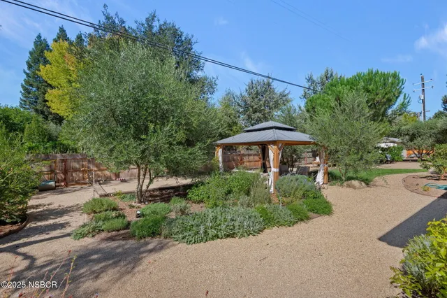 a patio with wooden table and chairs