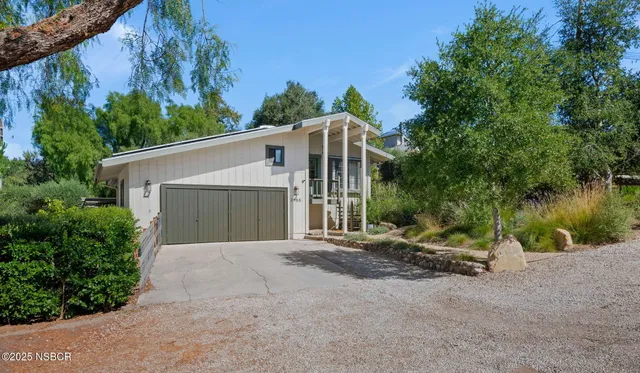 a front view of a house with a yard and a garage