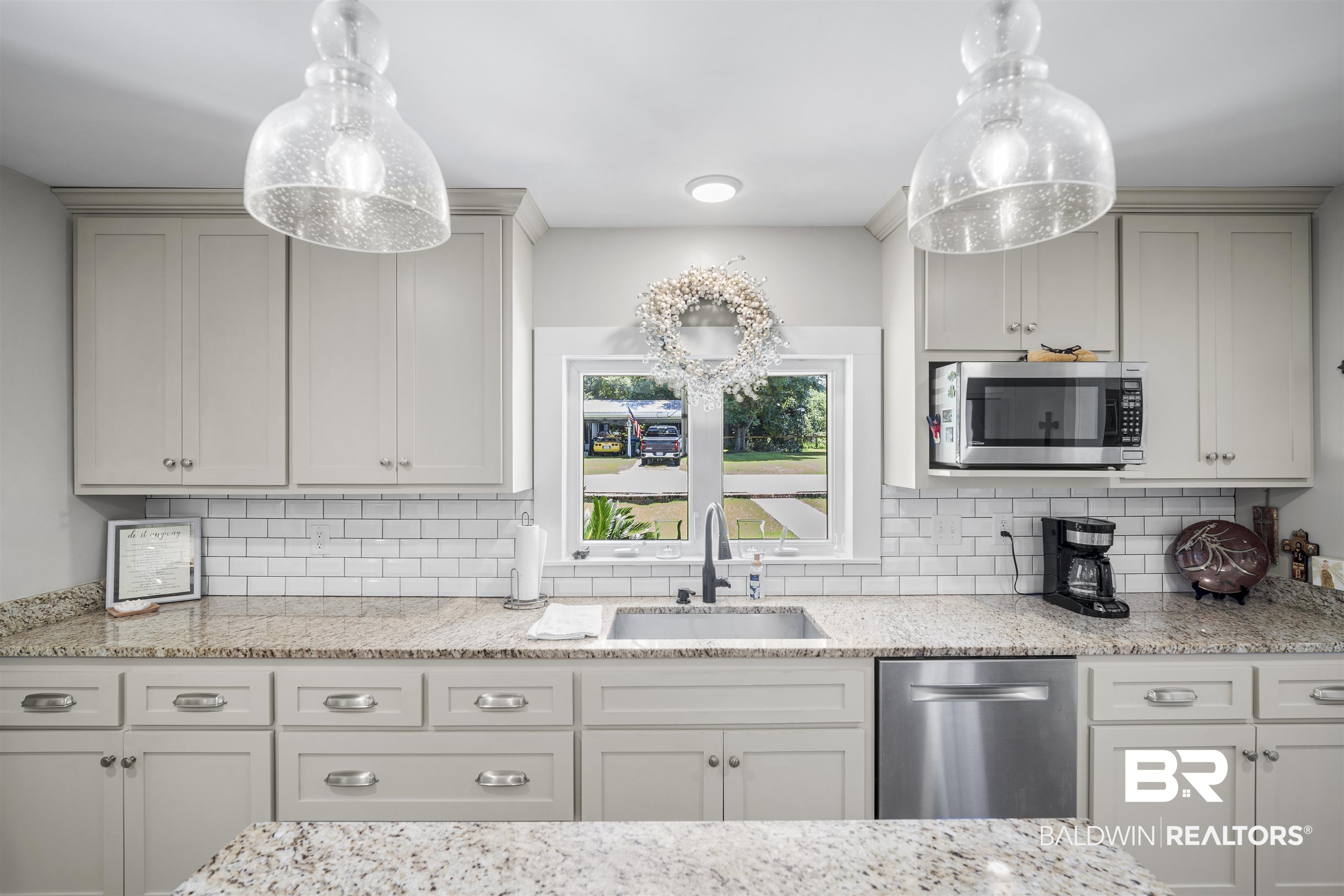 1615 5th Street Daphne, AL 36526 - Photo 7 of 28 Kitchen featuring light-colored cabinetry, speckled granite countertops, a subway tile backsplash, and a stainless steel dishwasher