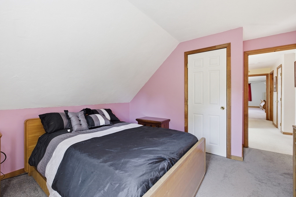 19 Mockingbird Lane Maynard, MA 01754 - Photo 18 of 34 a bedroom with a bed and a mirror