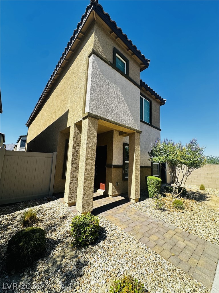 7331 Sunray Point Street North Las Vegas, NV 89084 - Photo 14 of 20 A striking contemporary residence boasts a unique textured facade and a welcoming paved walkway.