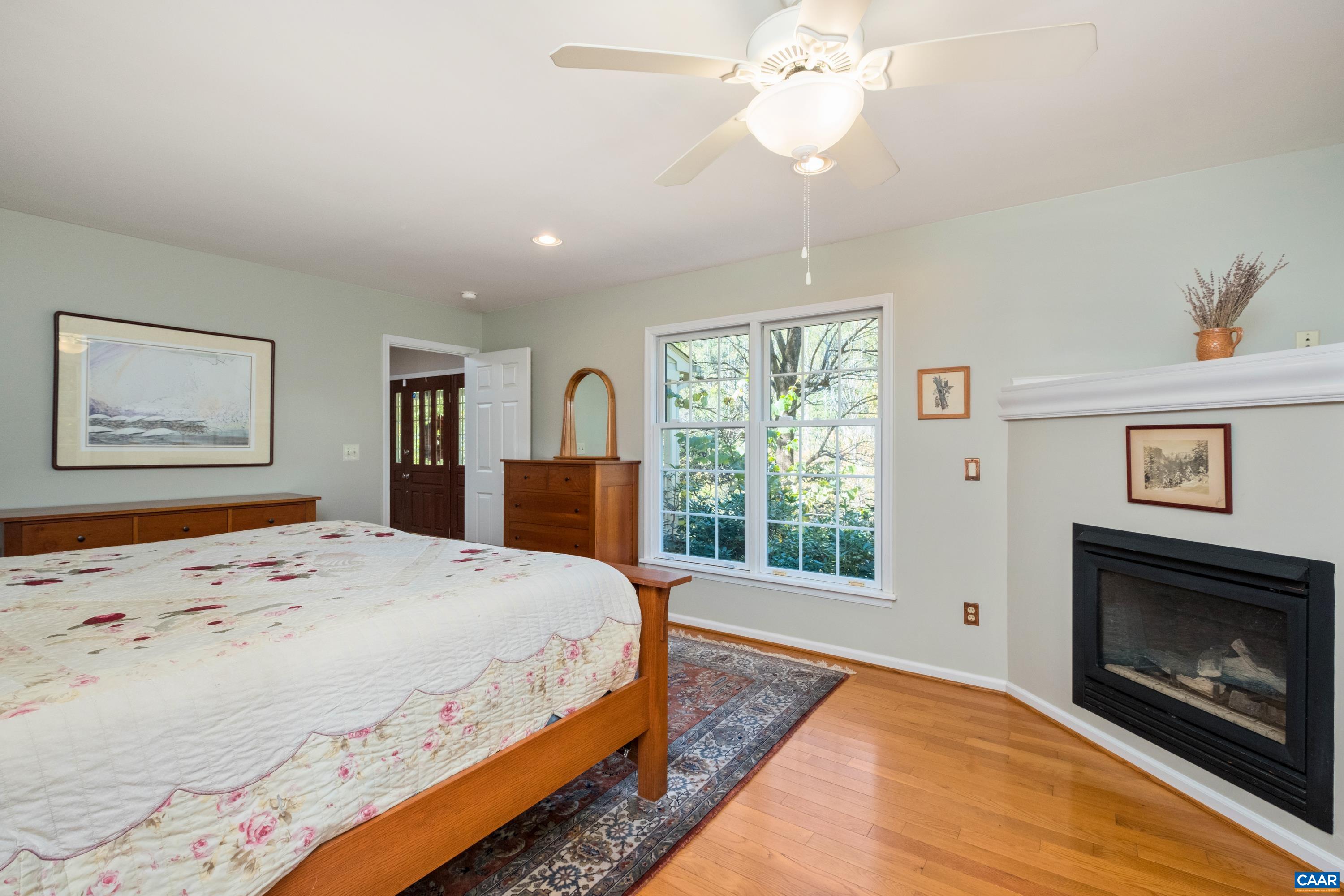 4375 Taylor Creek Road Afton, VA 22920 - Photo 35 of 75 a spacious bedroom with a large bed and a fireplace