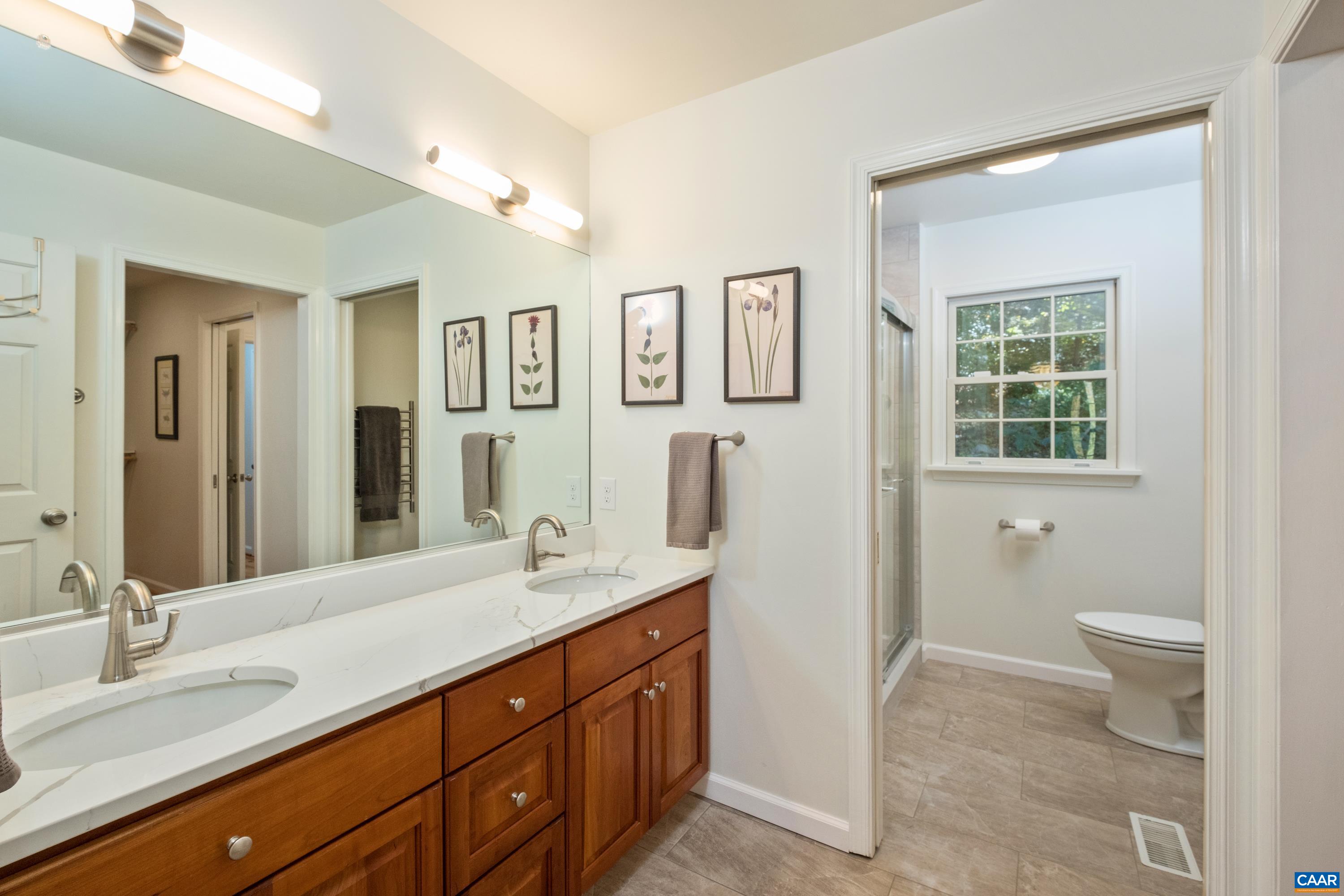 4375 Taylor Creek Road Afton, VA 22920 - Photo 37 of 75 a spacious bathroom with a double vanity sink a large mirror and a toilet