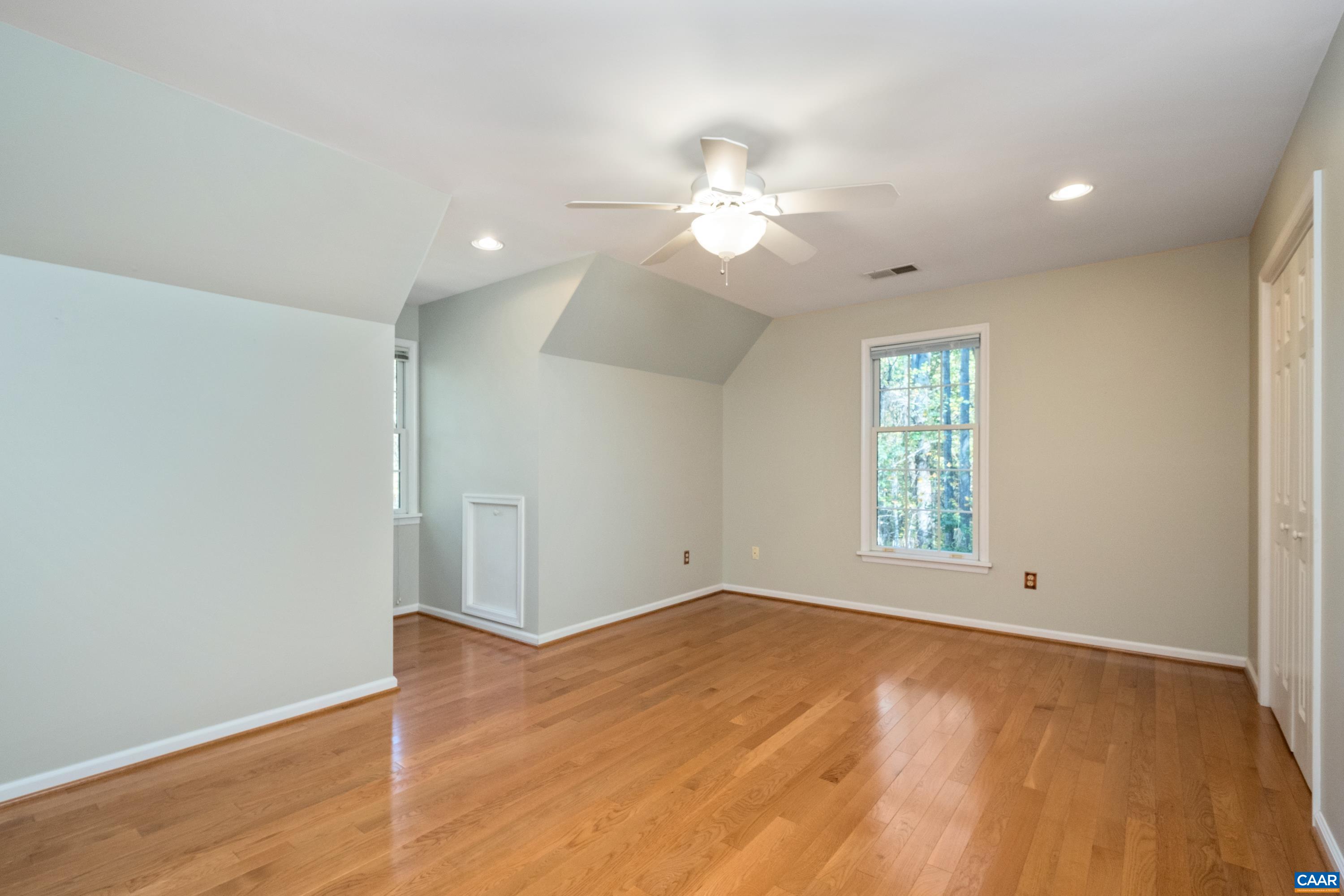 4375 Taylor Creek Road Afton, VA 22920 - Photo 45 of 75 an empty room with wooden floor fan and windows