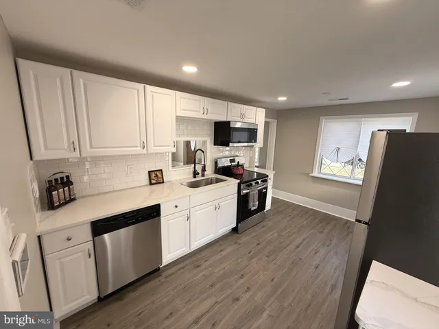 a kitchen with metallic refrigerator freezer and a dishwasher